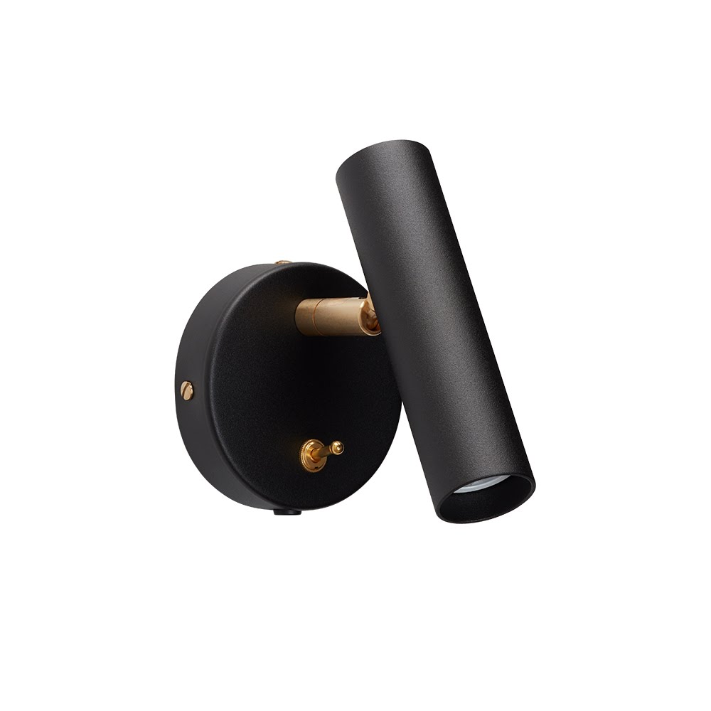 Applique murale orientable, cylindre acier noir mat et accastillage laiton brossé, interrupteur à bascule, fond neutre