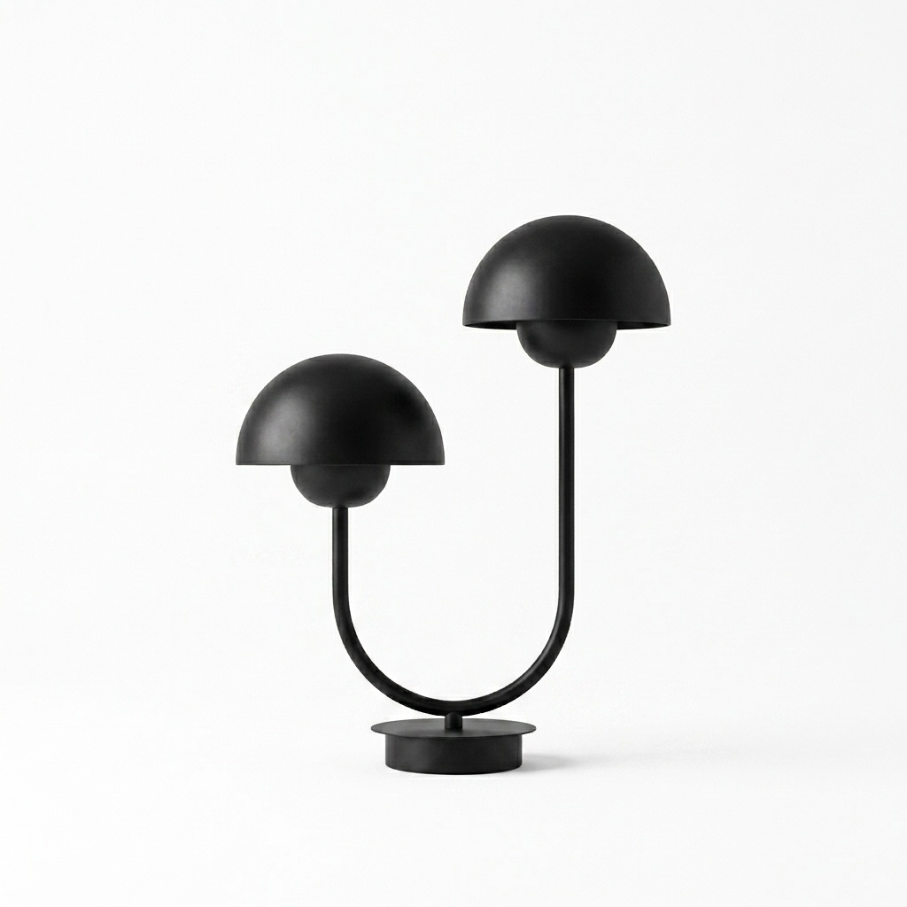 Lampe à poser en fer laqué noir mat, bras en U et deux coupoles hémisphériques décalées sur base disque, fond neutre