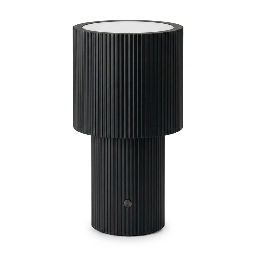 Lampe à poser portable en aluminium anodisé noir jet, silhouette à deux cylindres cannelés, fond neutre clair.