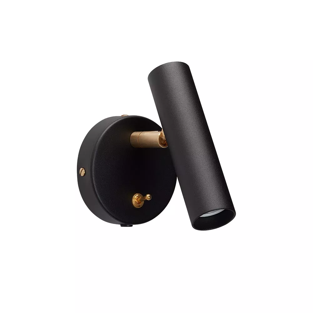 Applique murale orientable, cylindre acier noir mat et accastillage laiton brossé, interrupteur à bascule, fond neutre