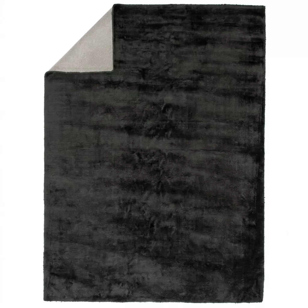 Tapis viscose anthracite avec coin replié, vue zénithale fond neutre, dos en toile coton beige, format rectangulaire