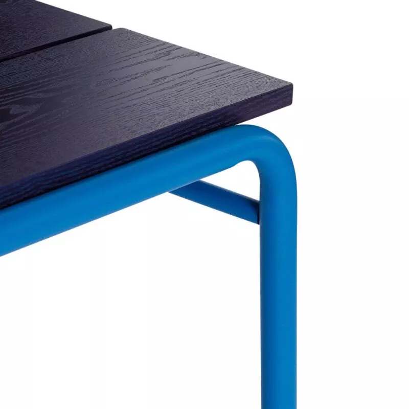 Détail jointure plateau placage frêne bleu marine et tube fer laqué bleu vif, grain du bois et finition laque satinée mate