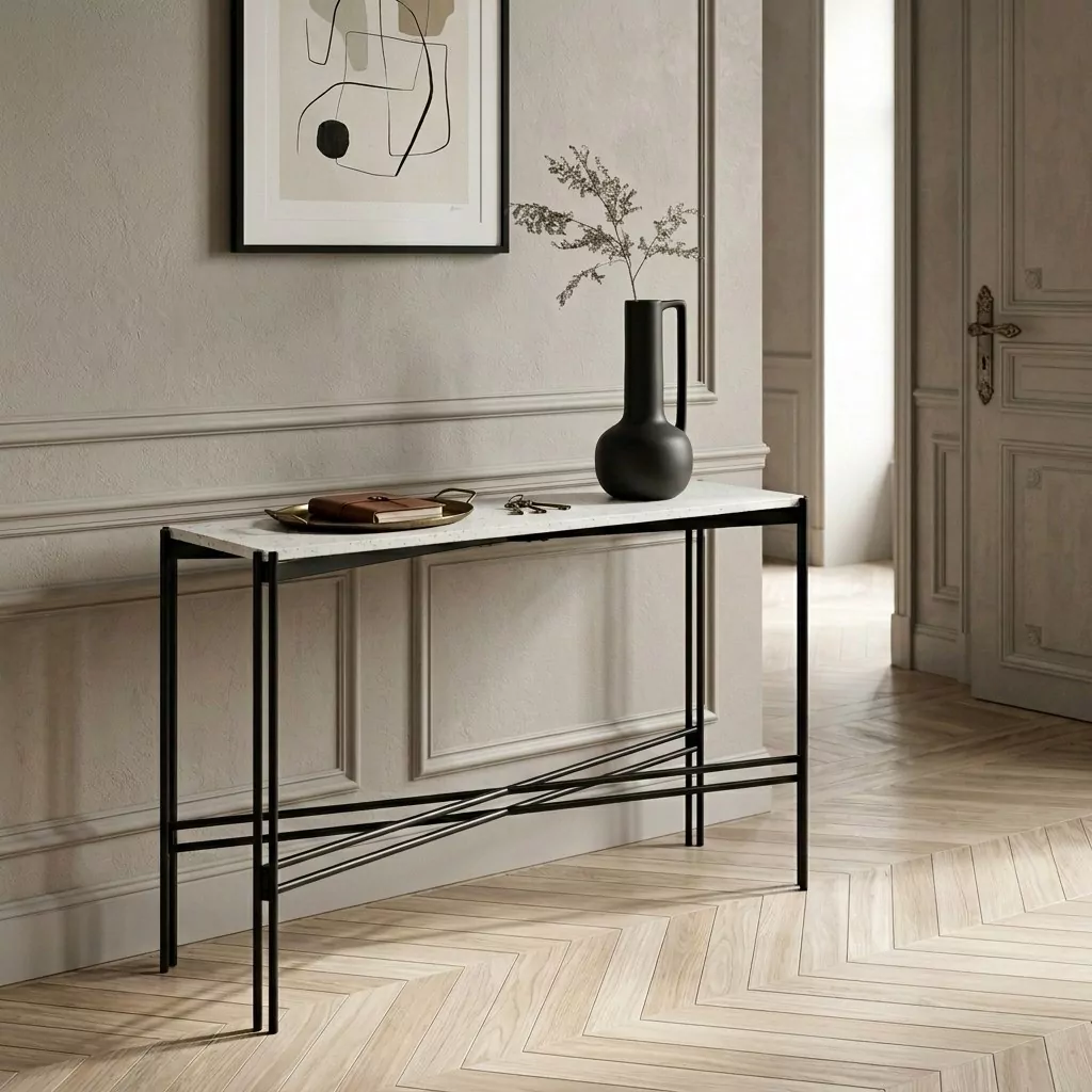 Console au plateau en terrazzo blanc et piétement métal noir, mur à moulures, art abstrait encadré et parquet à chevrons