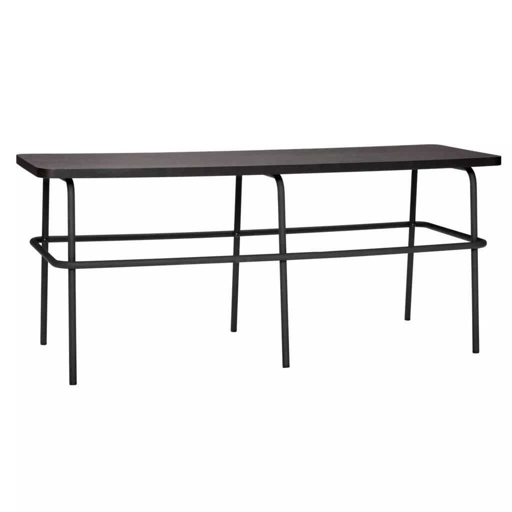 Banc en frêne teinté noir et métal mat, vue trois-quarts, plateau pincé en taille et piètement tubulaire à six pieds